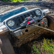 WARN ZEON XP 10-S 10,000 lb truck, Jeep, and SUV winch shown in muddy off-road terrain