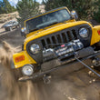 WARN ZEON XC 14-S 14,000 lb truck, Jeep, and SUV winch shown in sandy off-road terrain