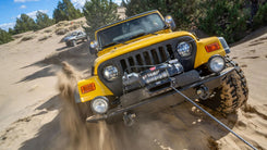WARN ZEON XC 14-S 14,000 lb truck, Jeep, and SUV winch shown in sandy off-road terrain